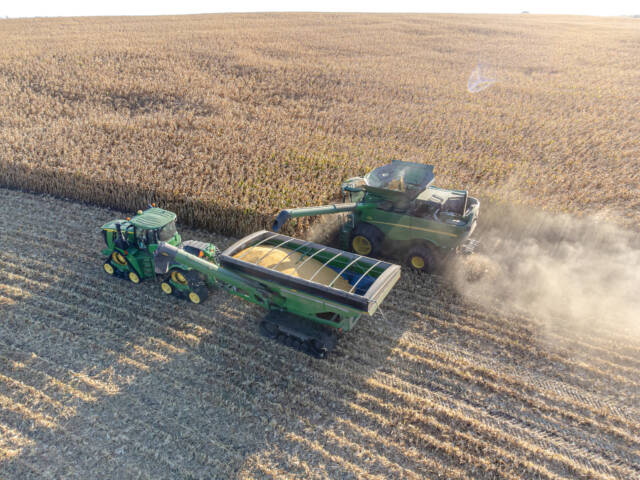 Combine unloading corn into a grain cart at harvest